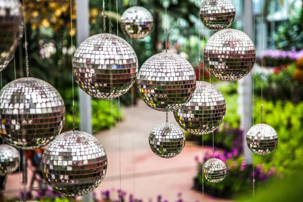 Disco Balls, Mirror Balls Hanging Outside In The Garden. Bright